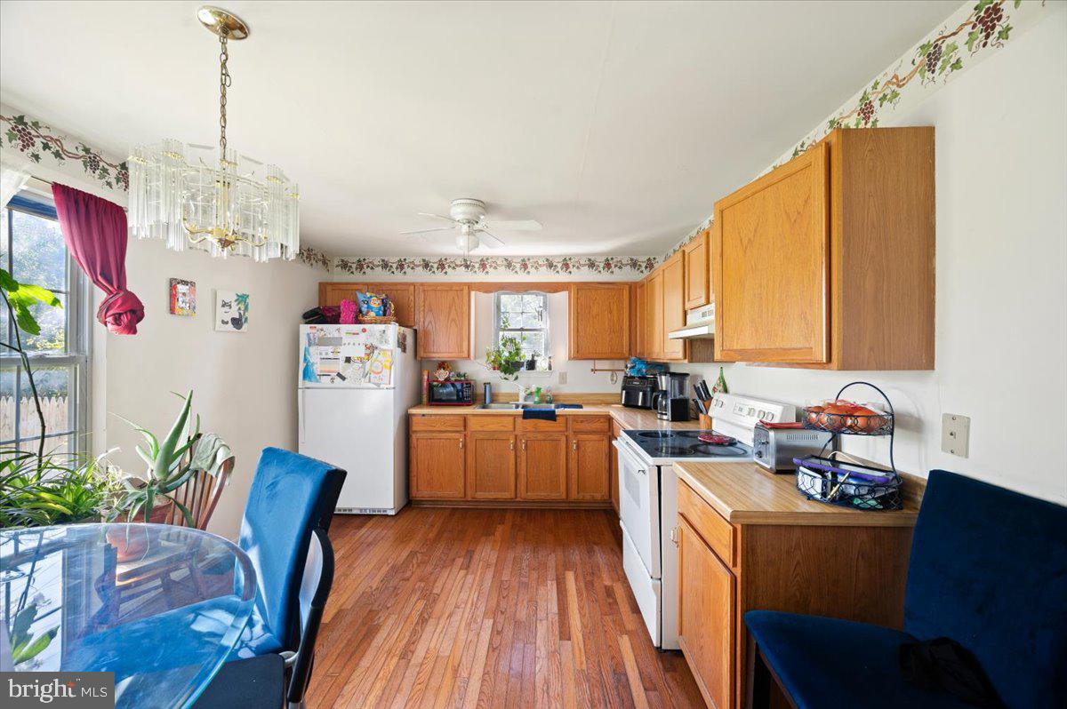 118 Ranson Estates Circle Ranson, WV 25438 - Photo 10 of 34 a kitchen with stainless steel appliances granite countertop a refrigerator a sink dishwasher a dining table and chairs with wooden floor