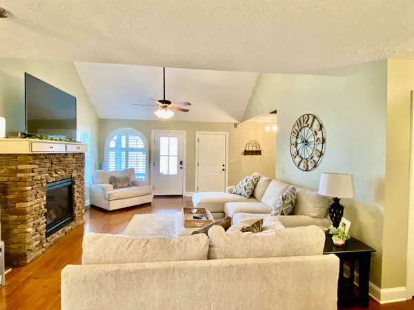 a living room with furniture and a flat screen tv