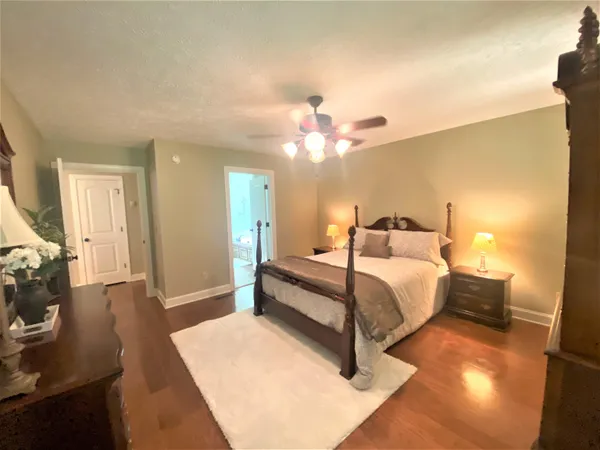 a spacious bedroom with a bed and a couch