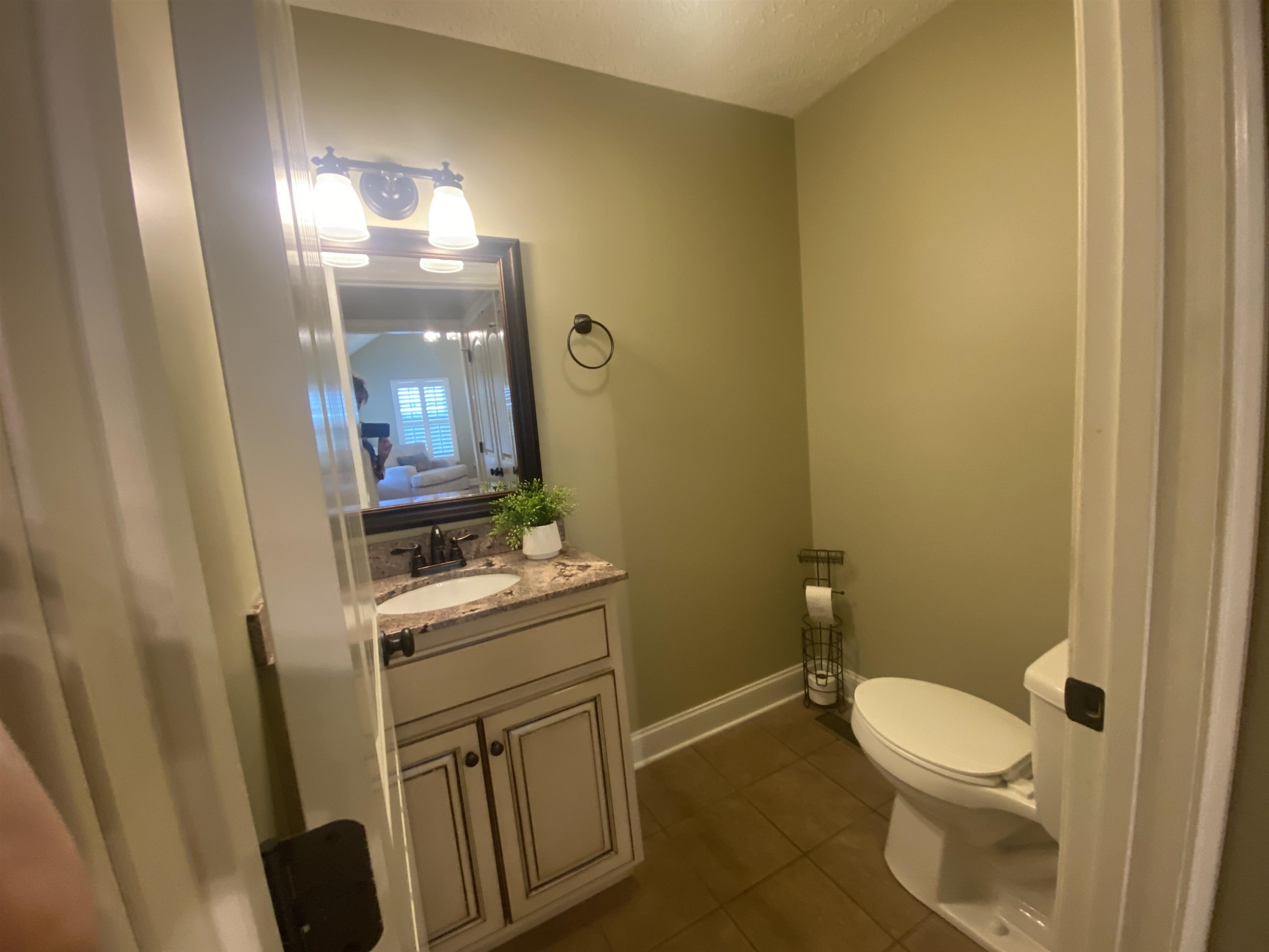 30 Masters Court Counce, TN 38326 - Photo 23 of 27 a bathroom with a granite countertop toilet sink and mirror
