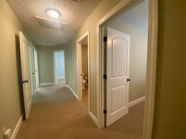 a view of a hallway with closet area