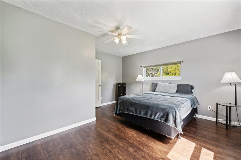 729 Athena Drive Export, PA 15632 - Photo 15 of 31 a spacious bedroom with a bed and a chandelier