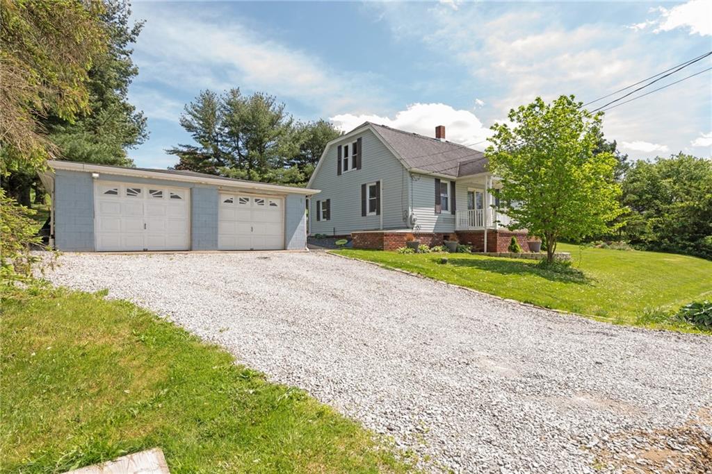 729 Athena Drive Export, PA 15632 - Photo 2 of 31 a front view of a house with a yard and garage
