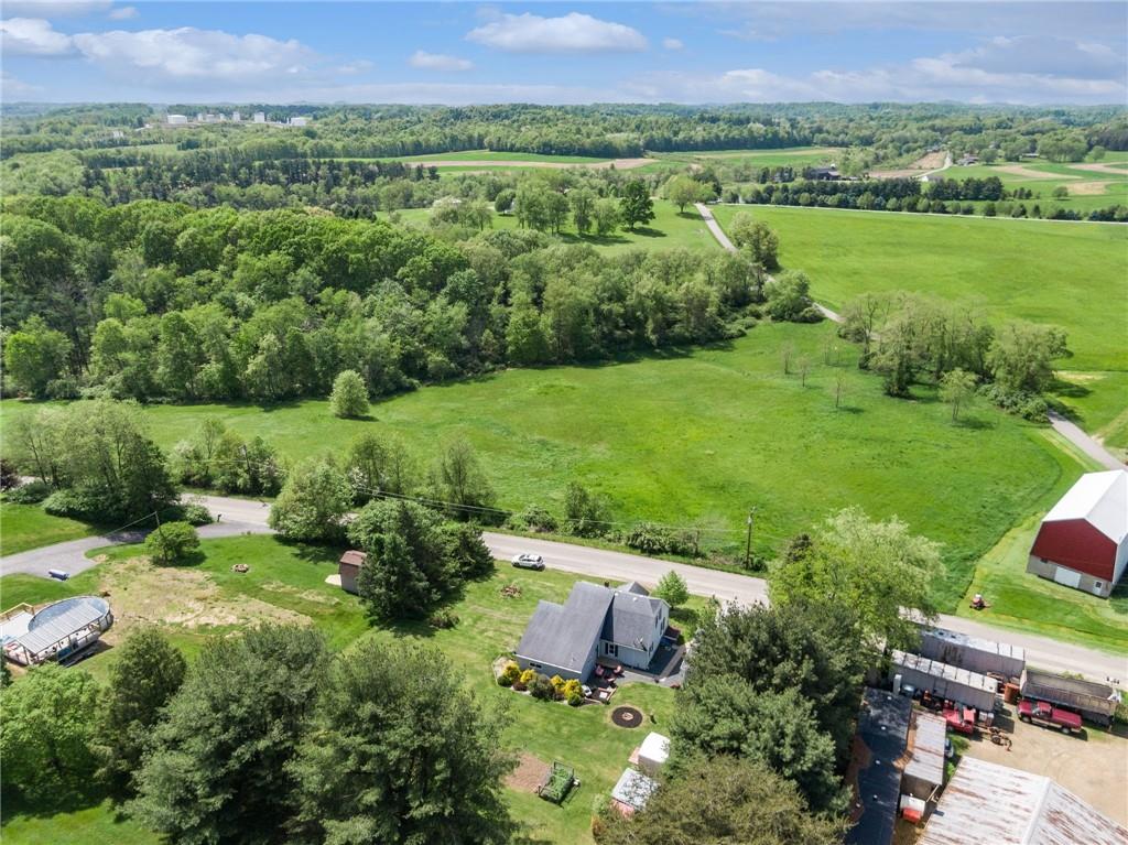 729 Athena Drive Export, PA 15632 - Photo 30 of 31 a view of a lush green field with couches and wooden fence