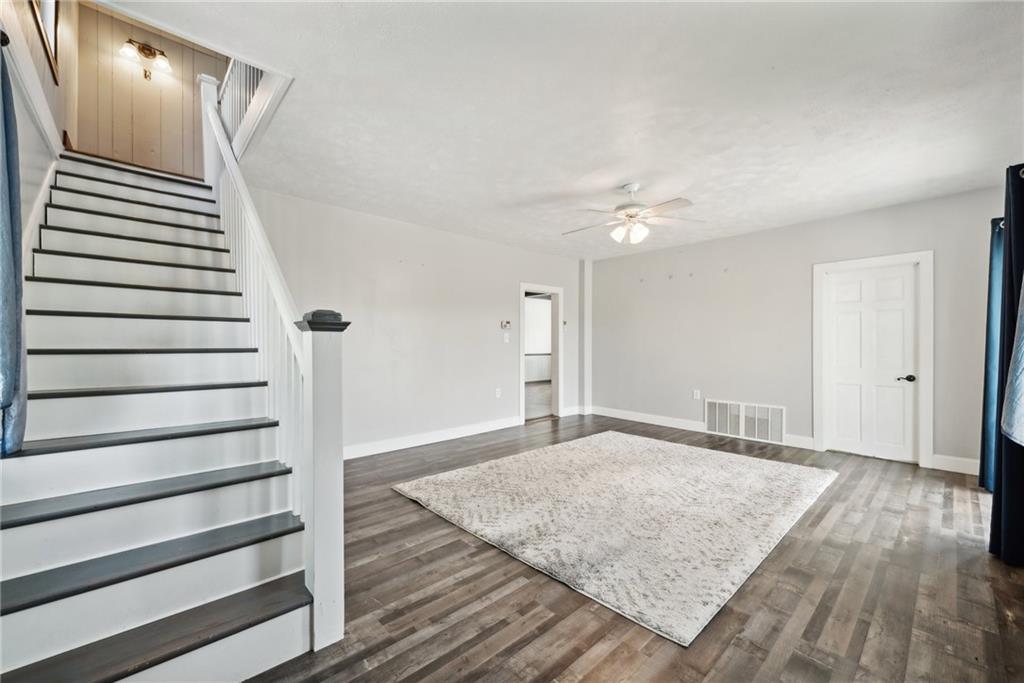 729 Athena Drive Export, PA 15632 - Photo 4 of 31 a view of a livingroom with wooden floor and stairs