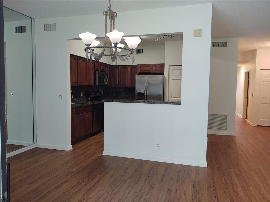 5801 Coach House Circle, Unit B Boca Raton, FL 33486 - Photo 13 of 39 Dining area with open concept kitchen
