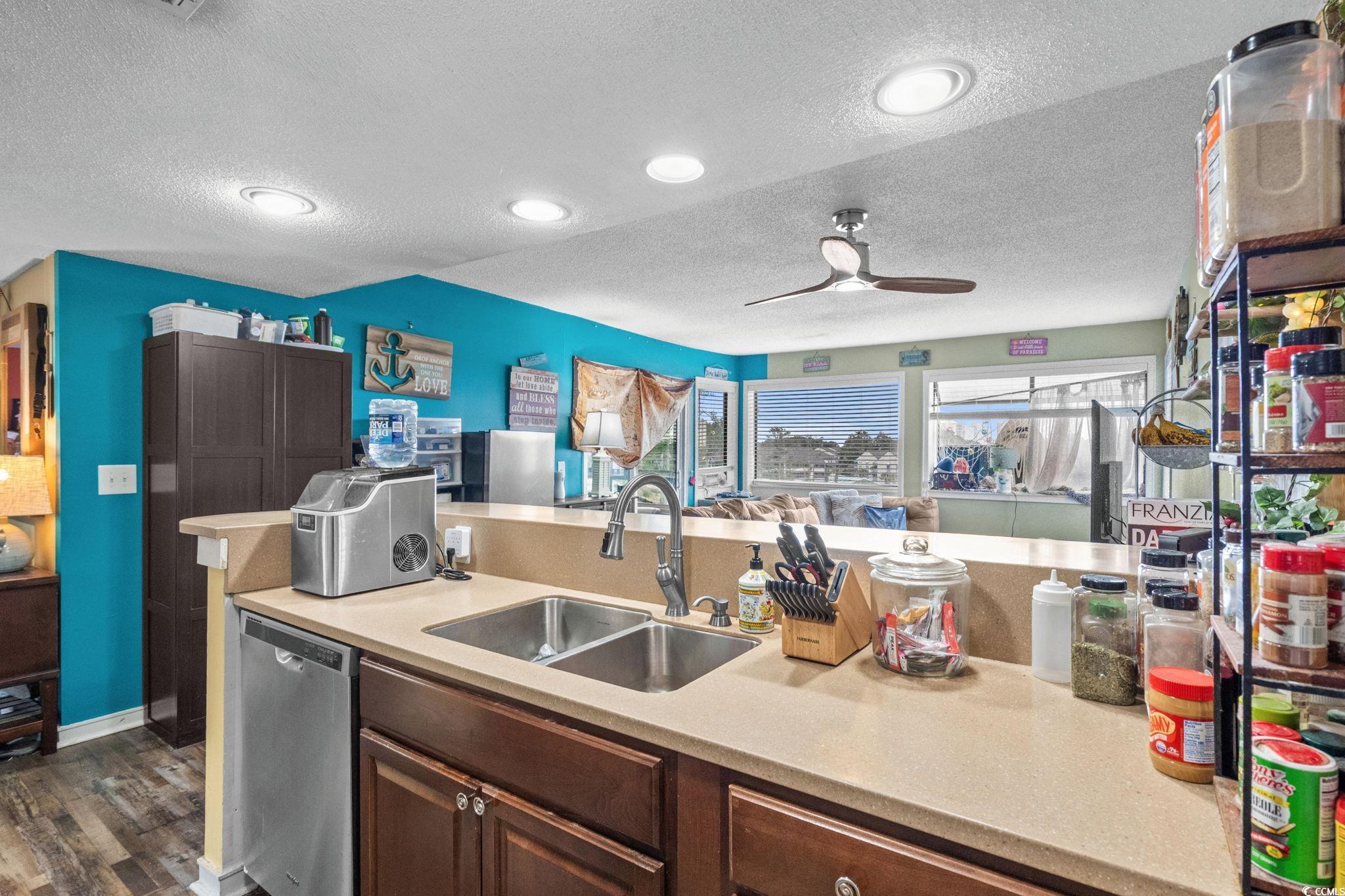 351 Lake Arrowhead Road, Unit 275 Myrtle Beach, SC 29572 - Photo 5 of 37 Kitchen with a textured ceiling, dishwasher, ceiling fan, dark wood-type flooring, and dark brown cabinetry