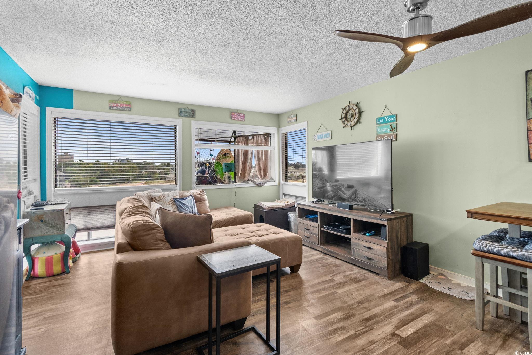 351 Lake Arrowhead Road, Unit 275 Myrtle Beach, SC 29572 - Photo 7 of 37 Living room featuring a textured ceiling, wood finished floors, and ceiling fan