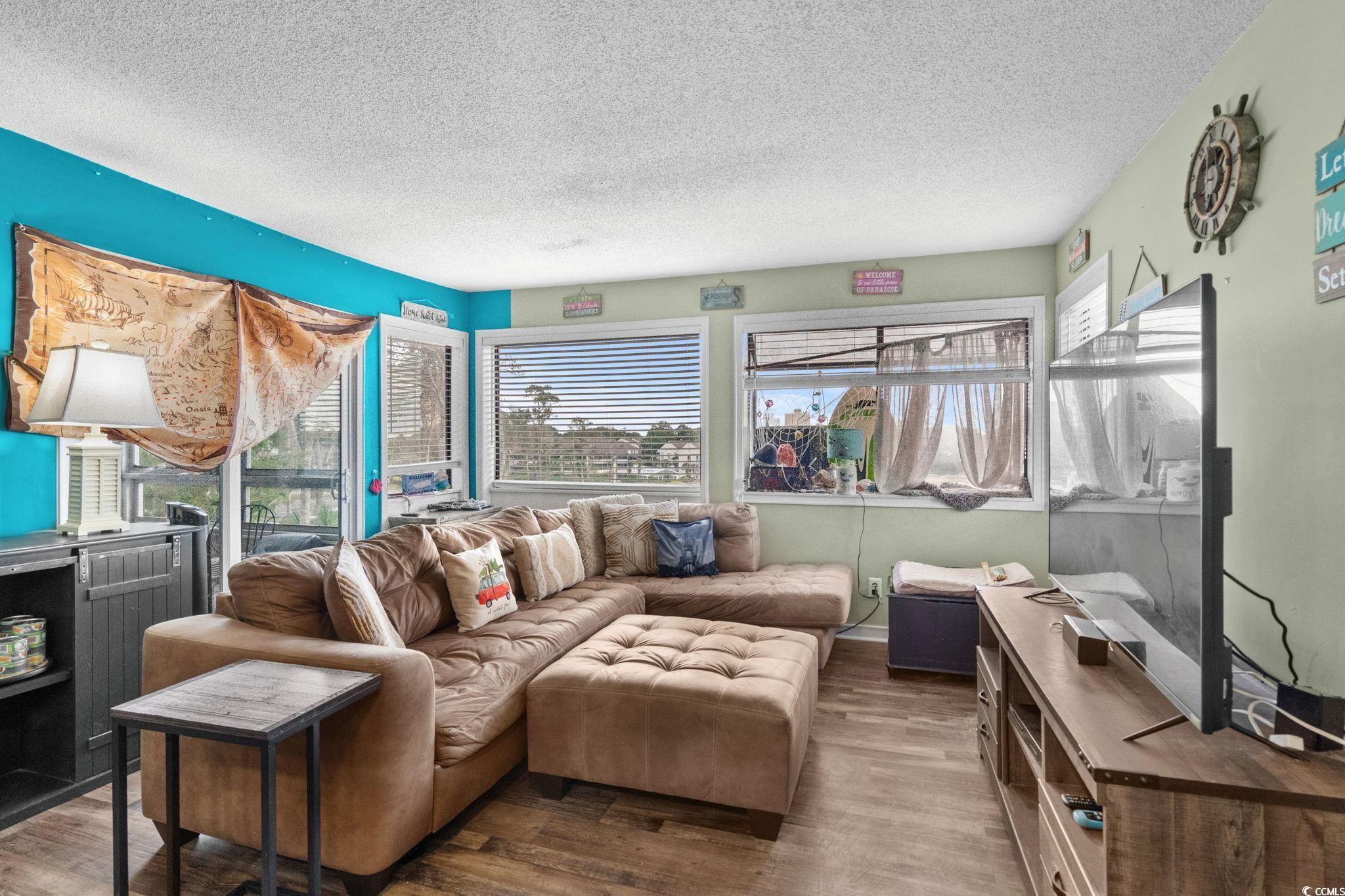 351 Lake Arrowhead Road, Unit 275 Myrtle Beach, SC 29572 - Photo 8 of 37 Living area featuring healthy amount of natural light, a textured ceiling, and wood finished floors