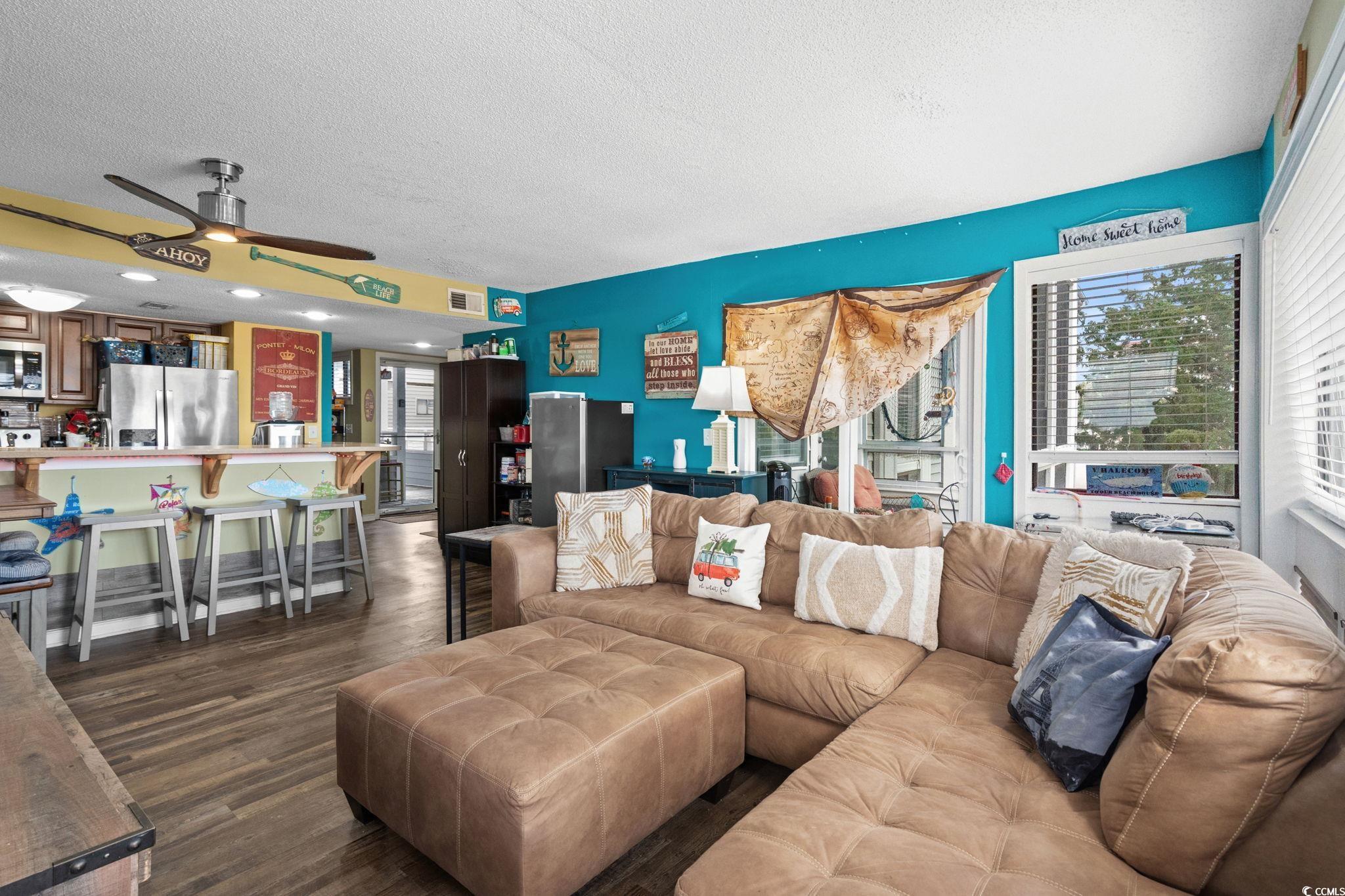 351 Lake Arrowhead Road, Unit 275 Myrtle Beach, SC 29572 - Photo 9 of 37 Living room with a textured ceiling, dark wood finished floors, ceiling fan, and plenty of natural light