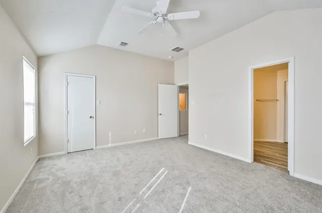 a view of an empty room and a window