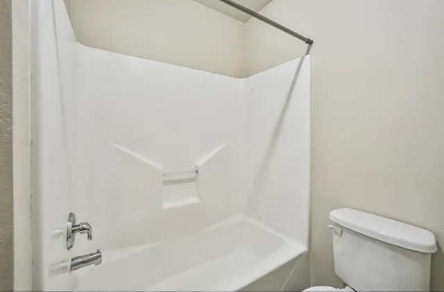 a bathroom with a bathtub and toilet
