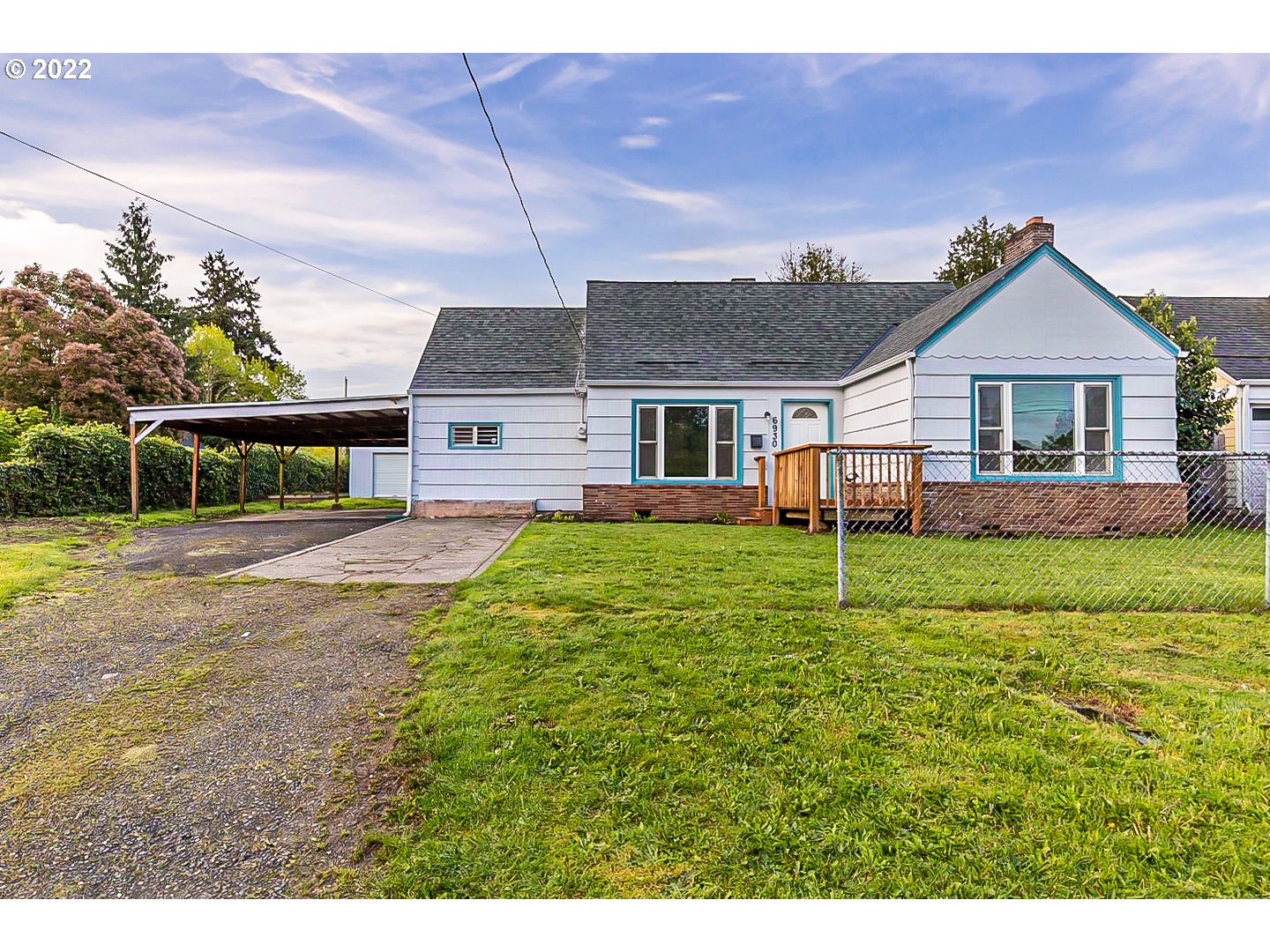 6930 Northeast Roselawn Street Portland, OR 97218 - Photo 1 of 31 a front view of a house with a yard