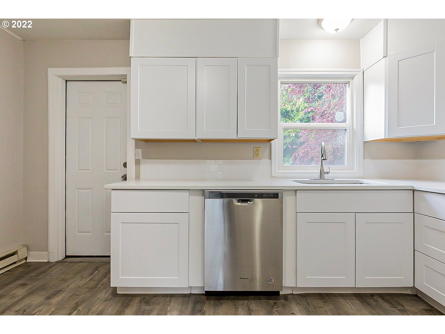 6930 Northeast Roselawn Street Portland, OR 97218 - Photo 13 of 31 a kitchen with white cabinets
