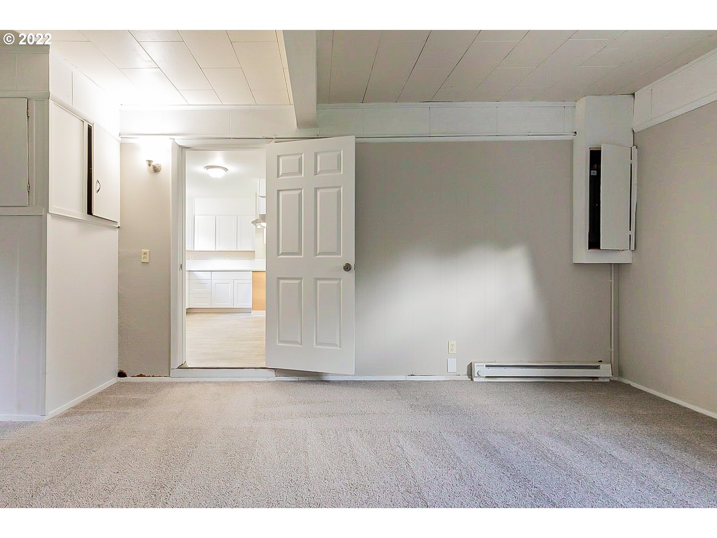 6930 Northeast Roselawn Street Portland, OR 97218 - Photo 16 of 31 a view of an empty room with wooden floor and a window