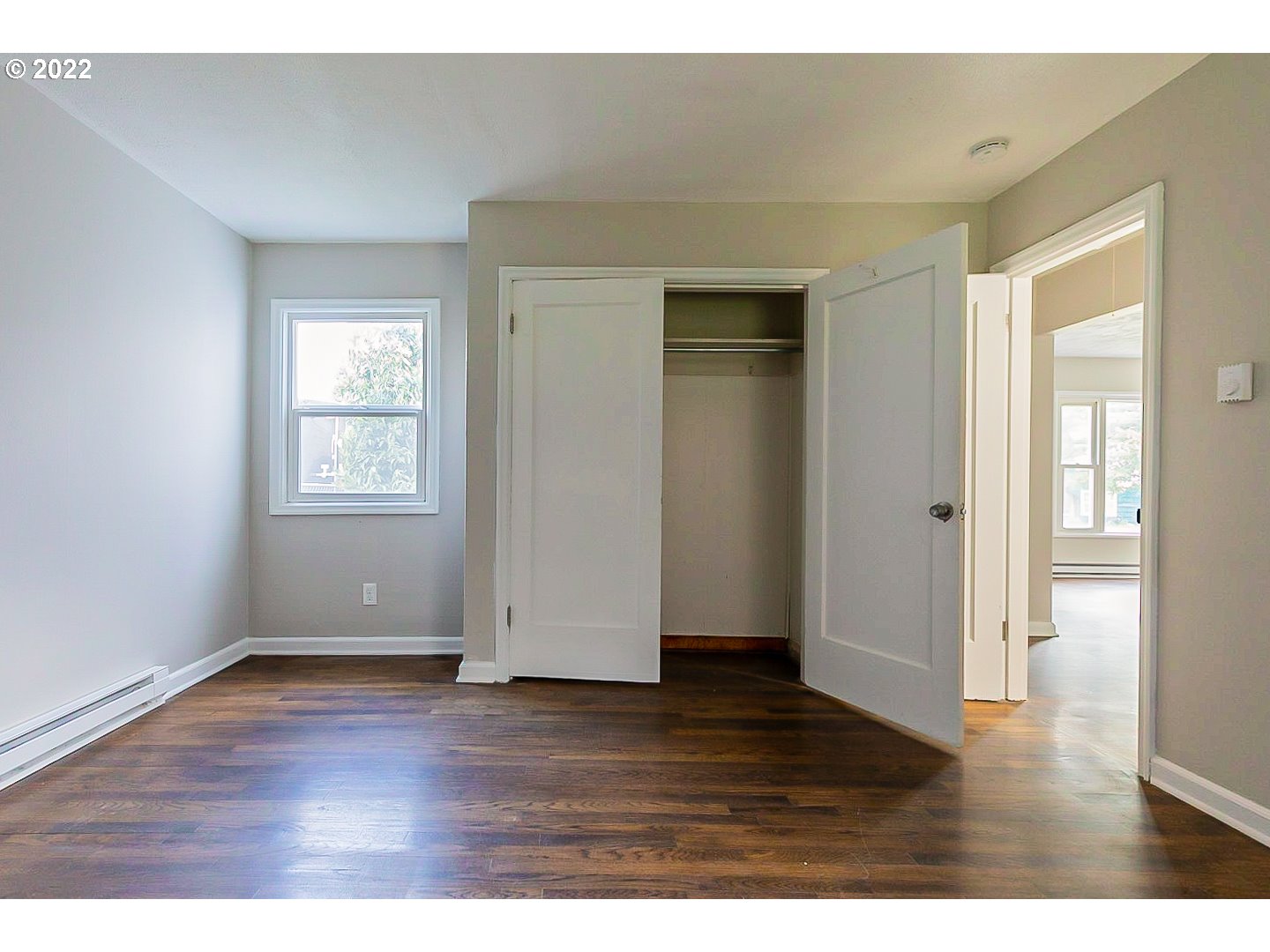 6930 Northeast Roselawn Street Portland, OR 97218 - Photo 20 of 31 a view of an empty room with wooden floor and a window