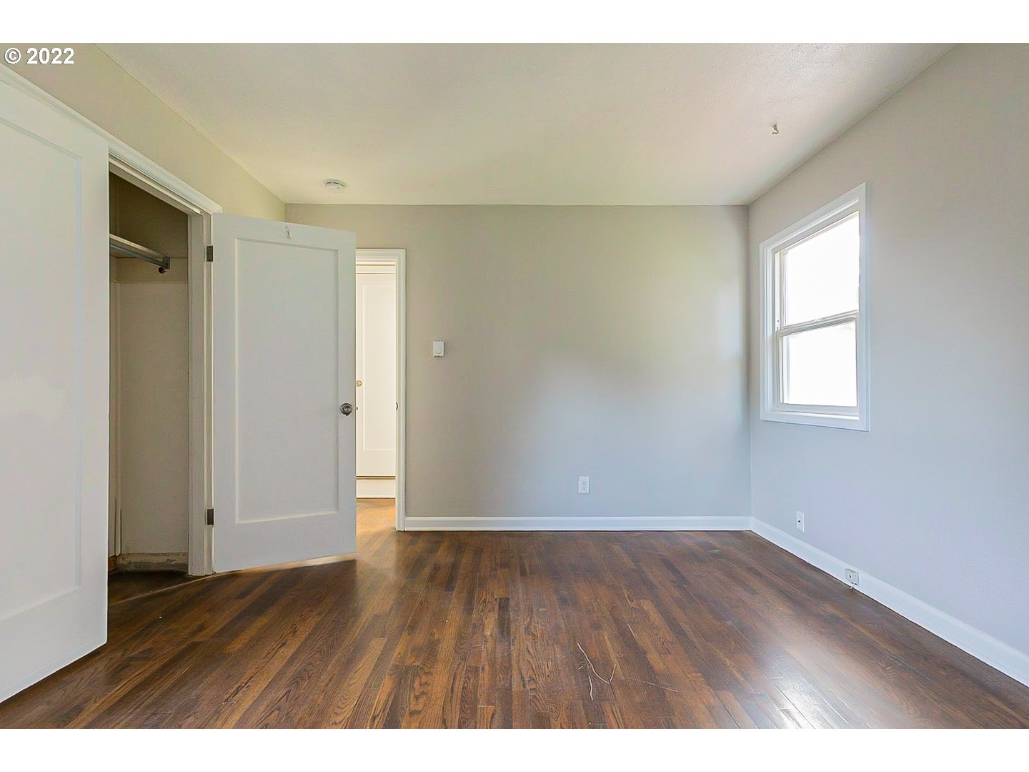 6930 Northeast Roselawn Street Portland, OR 97218 - Photo 21 of 31 a view of an empty room with wooden floor and a window