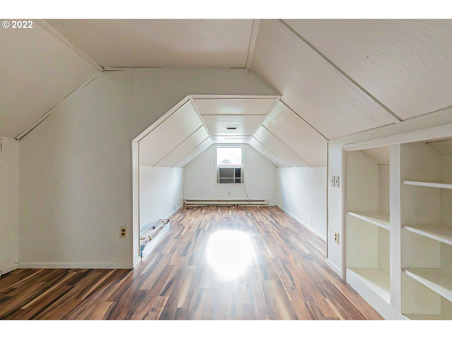 6930 Northeast Roselawn Street Portland, OR 97218 - Photo 23 of 31 a view of an empty room with wooden floor and a window