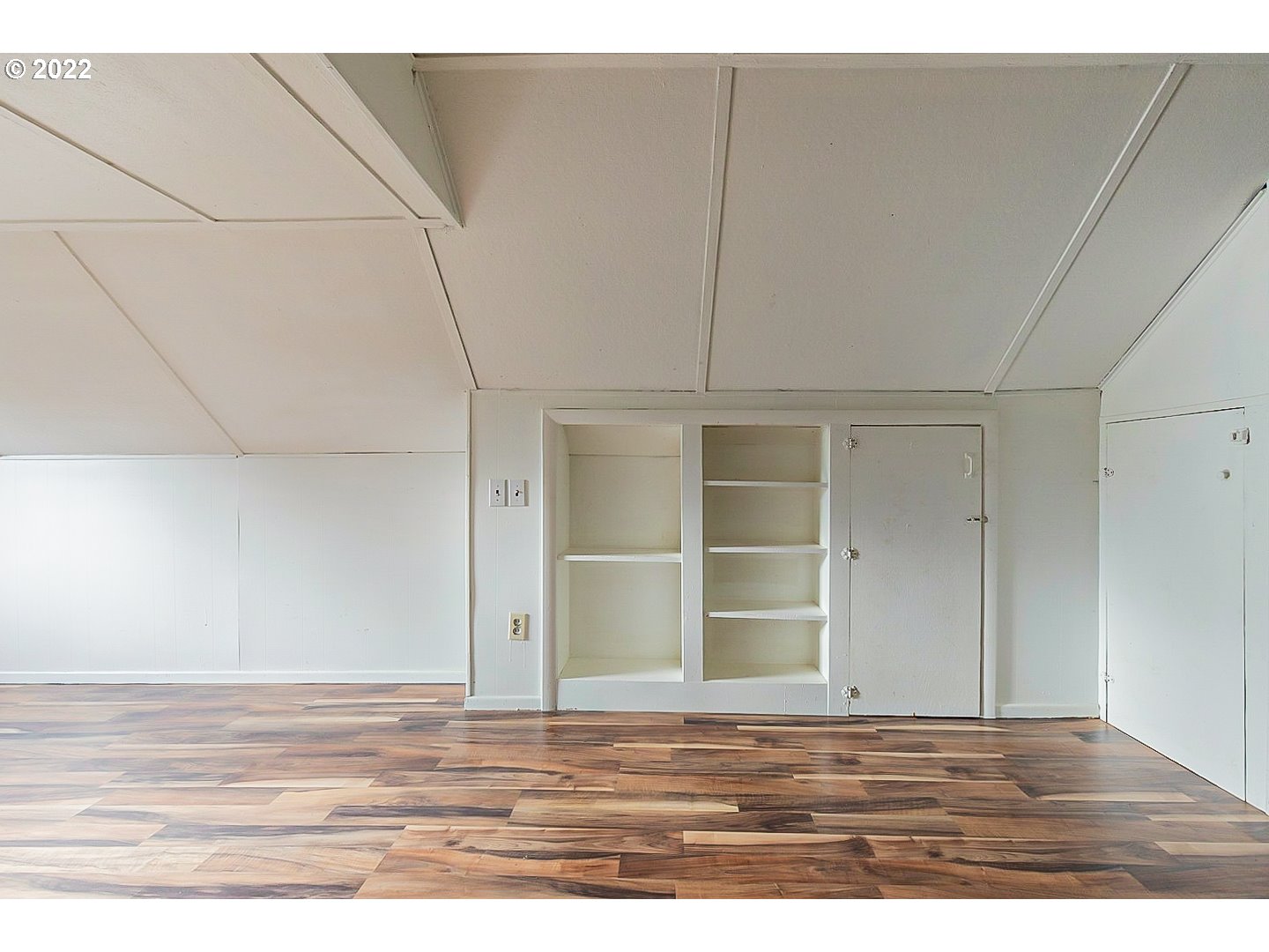 6930 Northeast Roselawn Street Portland, OR 97218 - Photo 24 of 31 a view of an empty room with wooden floor