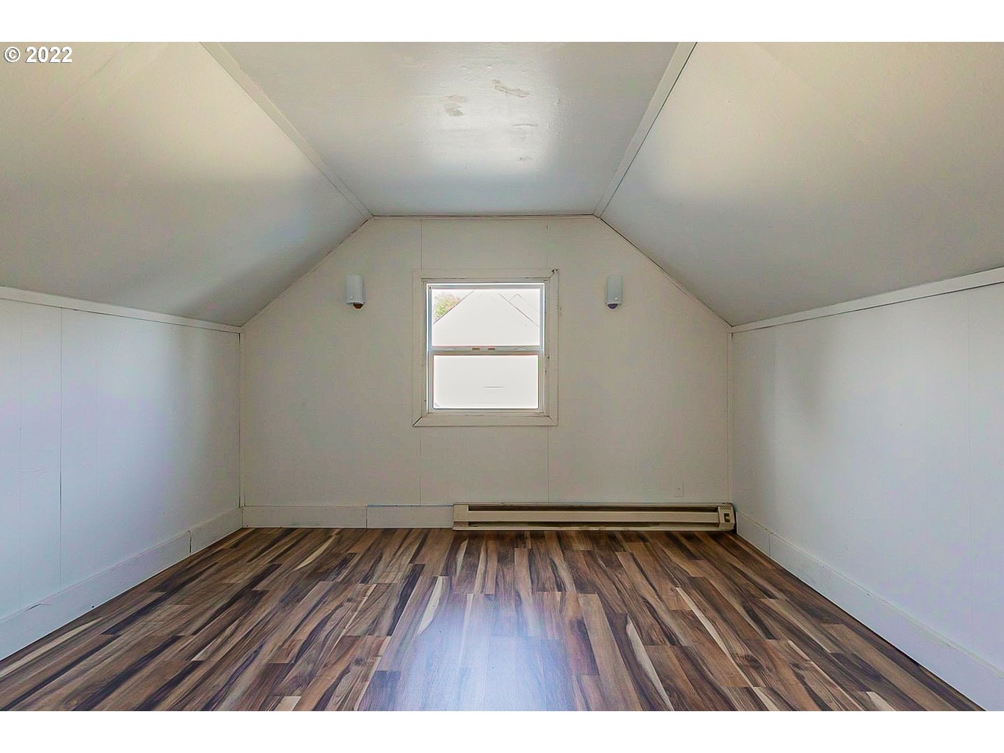 6930 Northeast Roselawn Street Portland, OR 97218 - Photo 27 of 31 a view of an empty room with wooden floor and a window