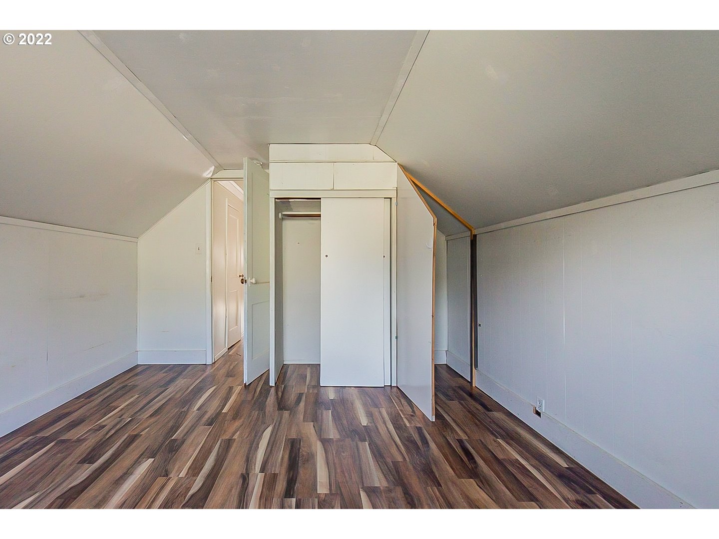 6930 Northeast Roselawn Street Portland, OR 97218 - Photo 28 of 31 a view of an empty room with wooden floor
