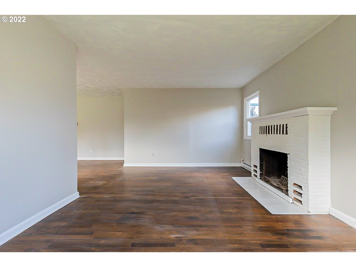 6930 Northeast Roselawn Street Portland, OR 97218 - Photo 6 of 31 a view of empty room with wooden floor