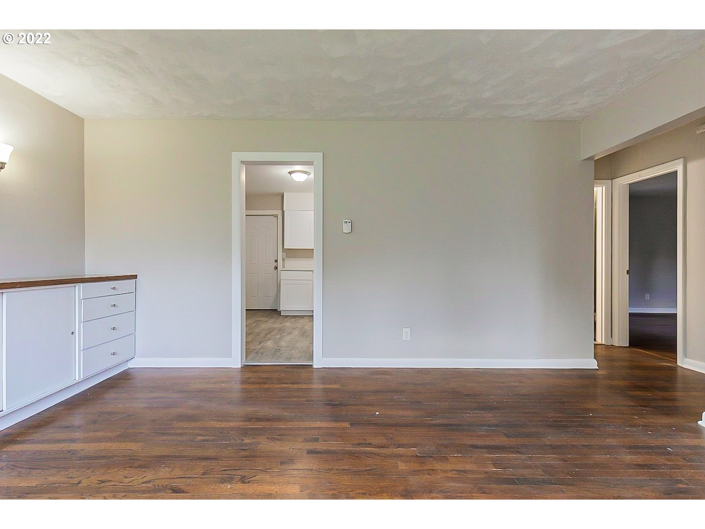6930 Northeast Roselawn Street Portland, OR 97218 - Photo 8 of 31 a view of an empty room and wooden floor