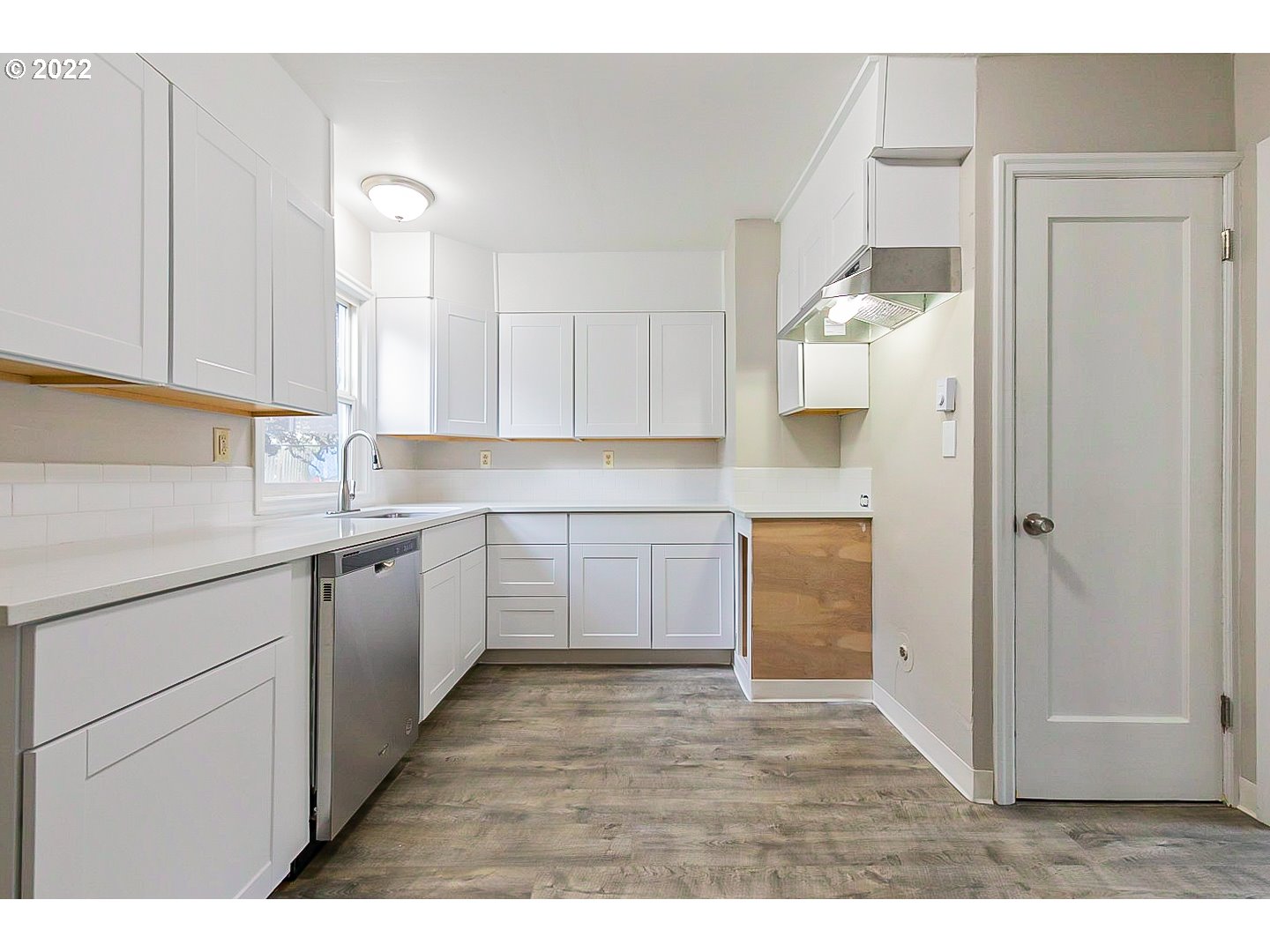 6930 Northeast Roselawn Street Portland, OR 97218 - Photo 10 of 31 a kitchen with a sink cabinets and window