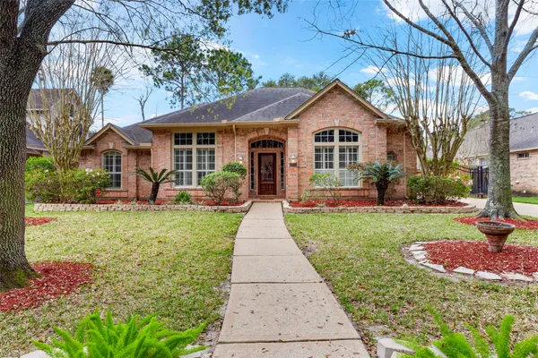 a view of a kitchen with kitchen island a refrigerator wooden floor and a dining table