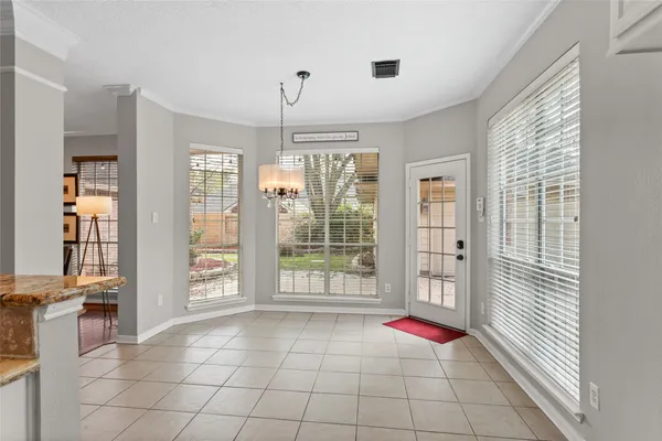 a room with natural light and hardwood floor