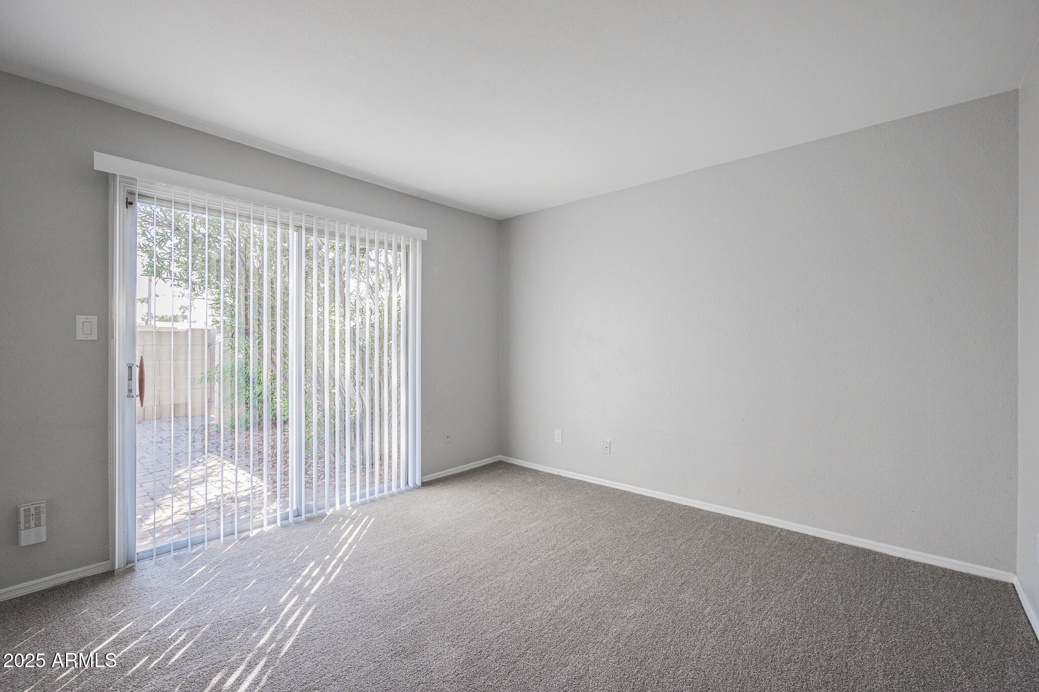 2135 South Dorsey Lane Tempe, AZ 85282 - Photo 11 of 24 a view of an empty room with wooden floor and a window