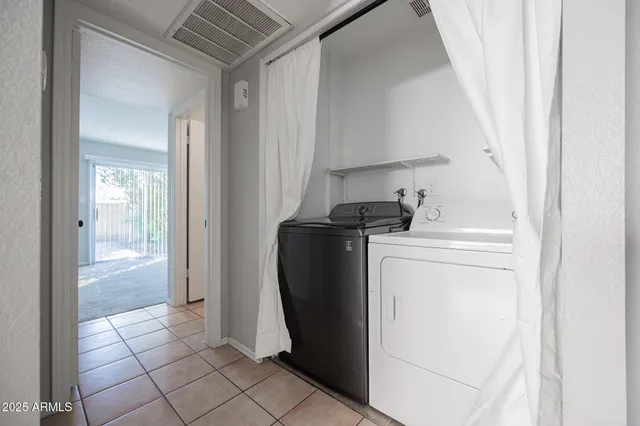 a view of a storage and utility room with washer and dryer