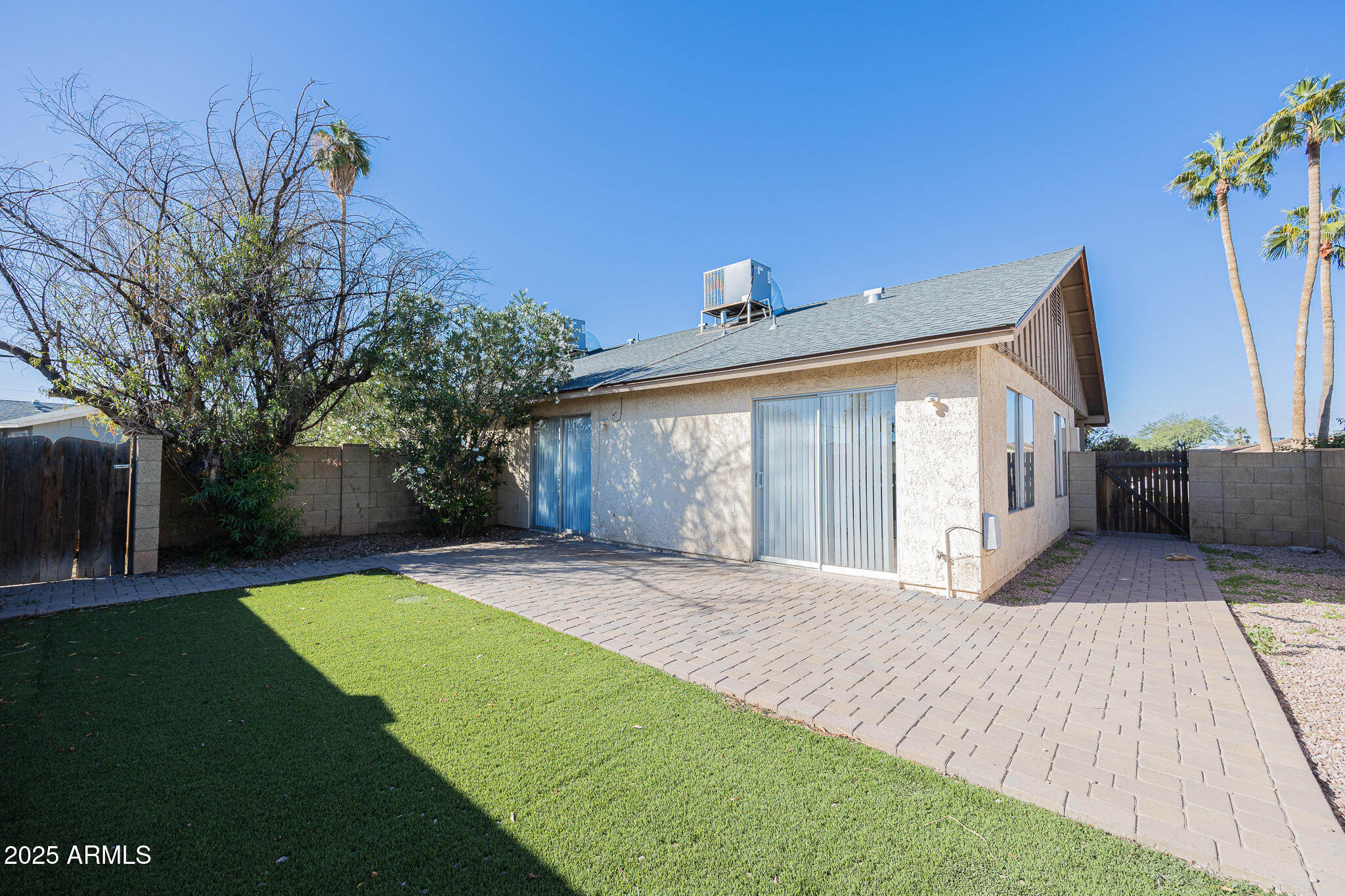 2135 South Dorsey Lane Tempe, AZ 85282 - Photo 23 of 24 a front view of a house with a yard and potted plants