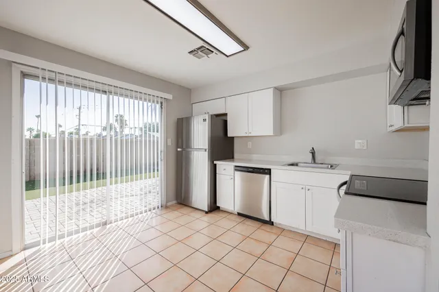 a kitchen with a sink cabinets and appliances