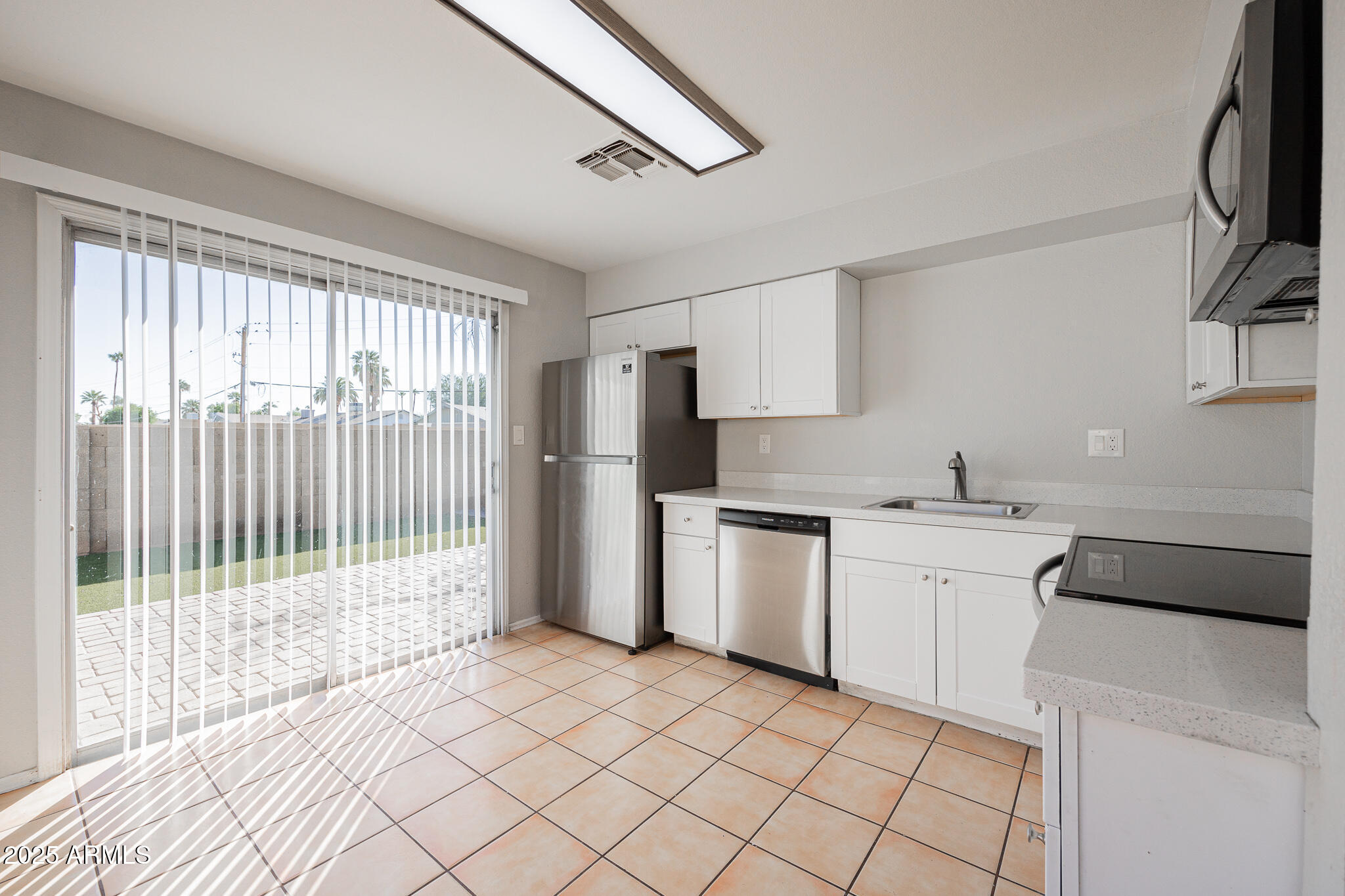 2135 South Dorsey Lane Tempe, AZ 85282 - Photo 8 of 24 a kitchen with a sink cabinets and appliances