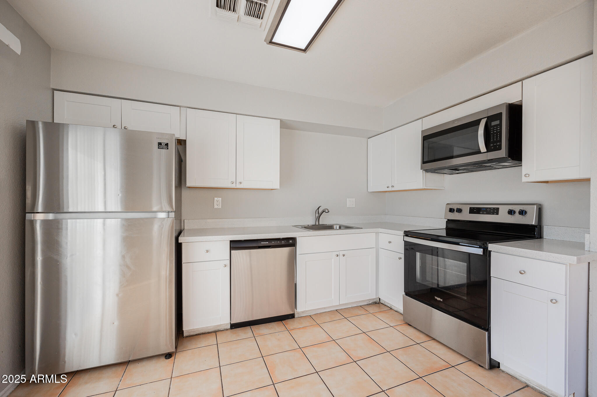 2135 South Dorsey Lane Tempe, AZ 85282 - Photo 9 of 24 a kitchen with stainless steel appliances granite countertop a refrigerator sink and stove