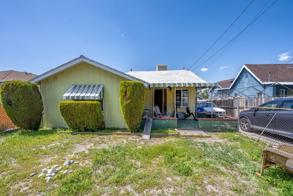a view of a house with a yard and sitting area
