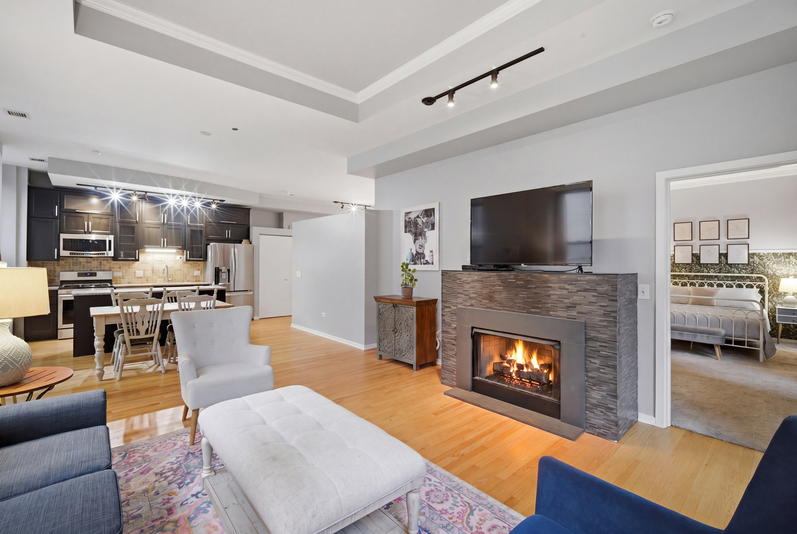 208 West Washington Street, Unit 910 Chicago, IL 60606 - Photo 11 of 18 a living room with furniture and a fireplace or television