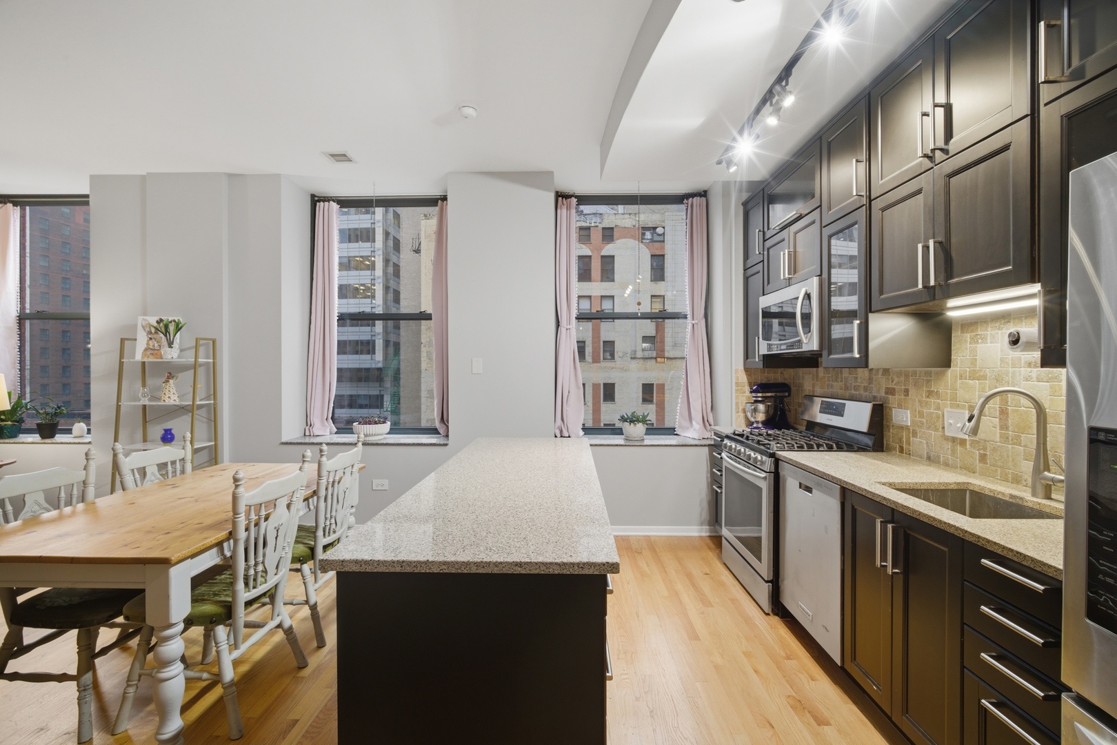 208 West Washington Street, Unit 910 Chicago, IL 60606 - Photo 4 of 18 a kitchen with stainless steel appliances granite countertop a sink stove and refrigerator