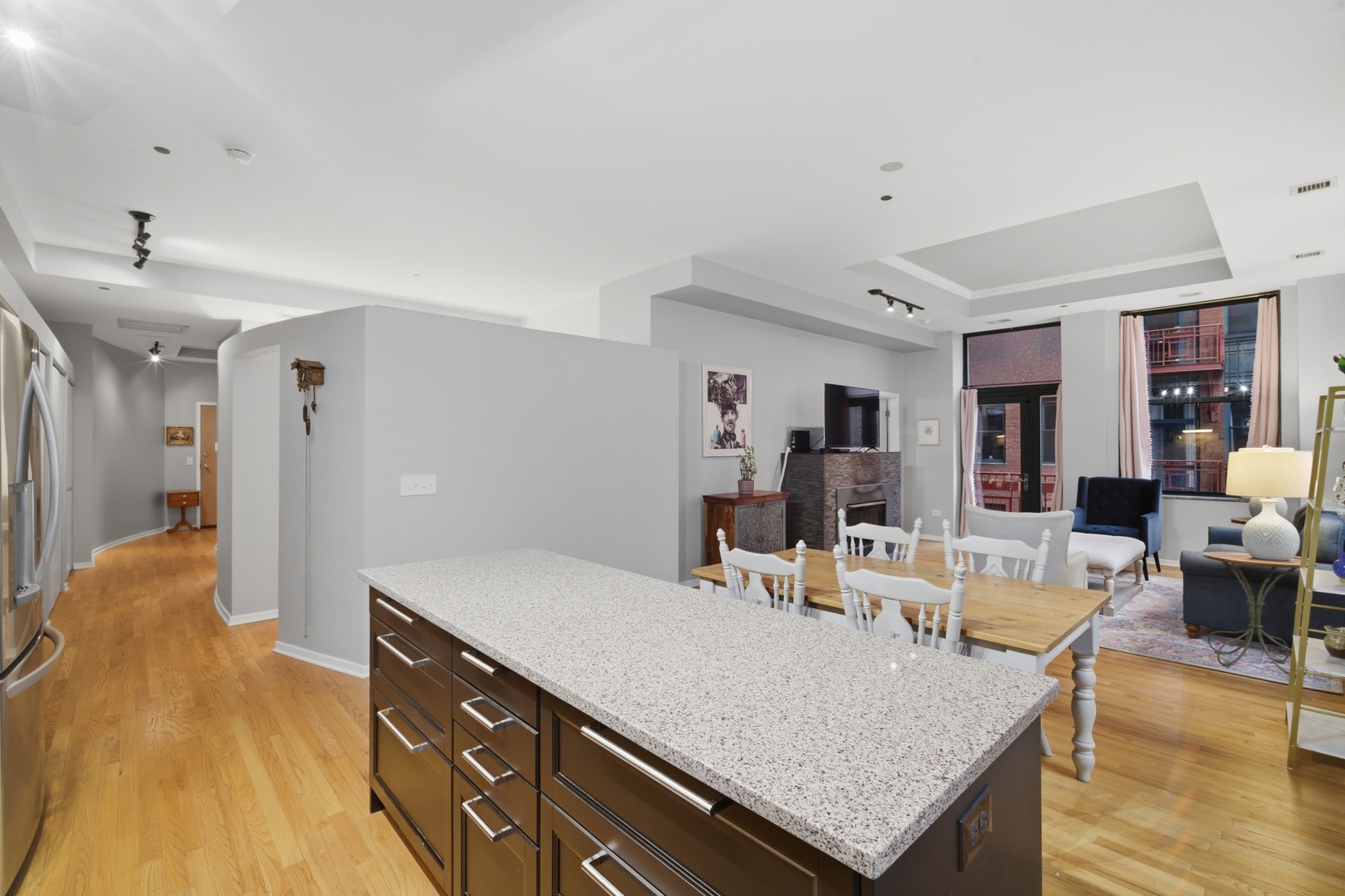 208 West Washington Street, Unit 910 Chicago, IL 60606 - Photo 7 of 18 a living room with stainless steel appliances granite countertop furniture and a wooden floor
