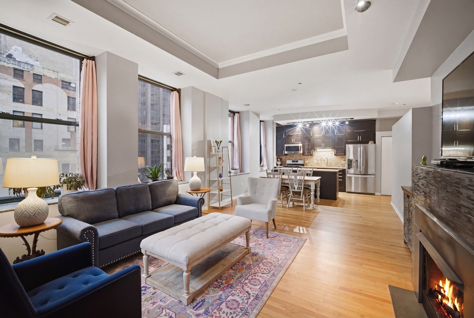 208 West Washington Street, Unit 910 Chicago, IL 60606 - Photo 9 of 18 a living room with furniture wooden floor and a flat screen tv