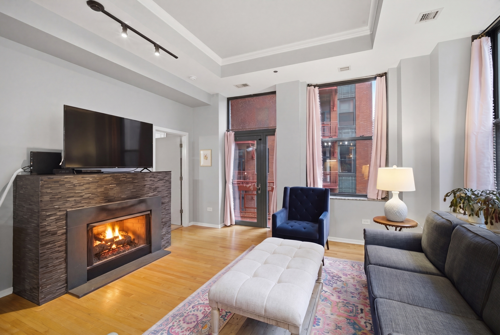 208 West Washington Street, Unit 910 Chicago, IL 60606 - Photo 10 of 18 a living room with furniture and a fireplace or television