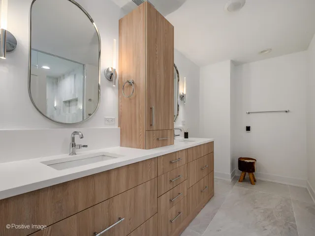 a bathroom with a double vanity sink and a mirror