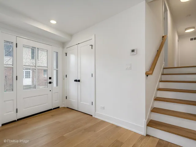 a view of an empty room with stairs and ventilation