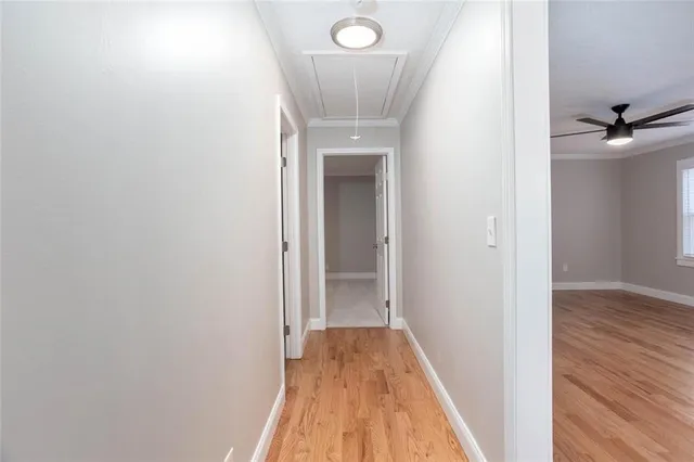 a view of a hallway with wooden floor