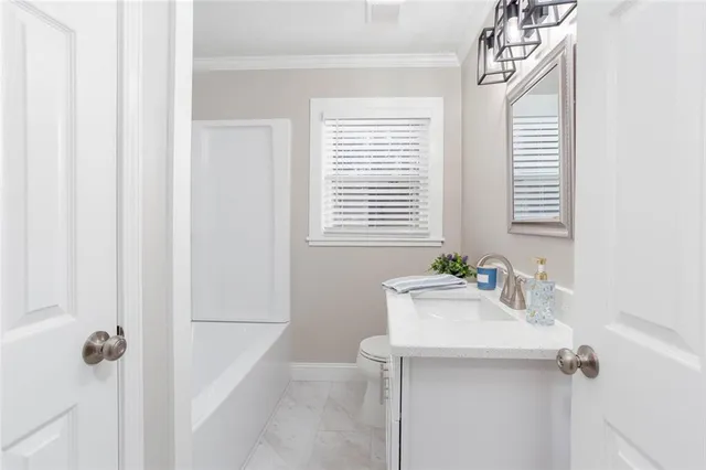 a bathroom with a sink a mirror and a window
