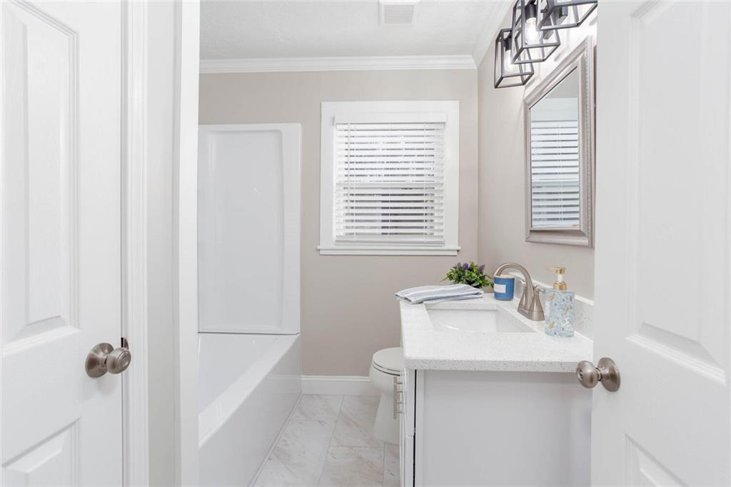3831 Dillard Street Powder Springs, GA 30127 - Photo 14 of 30 a bathroom with a sink a mirror and a window