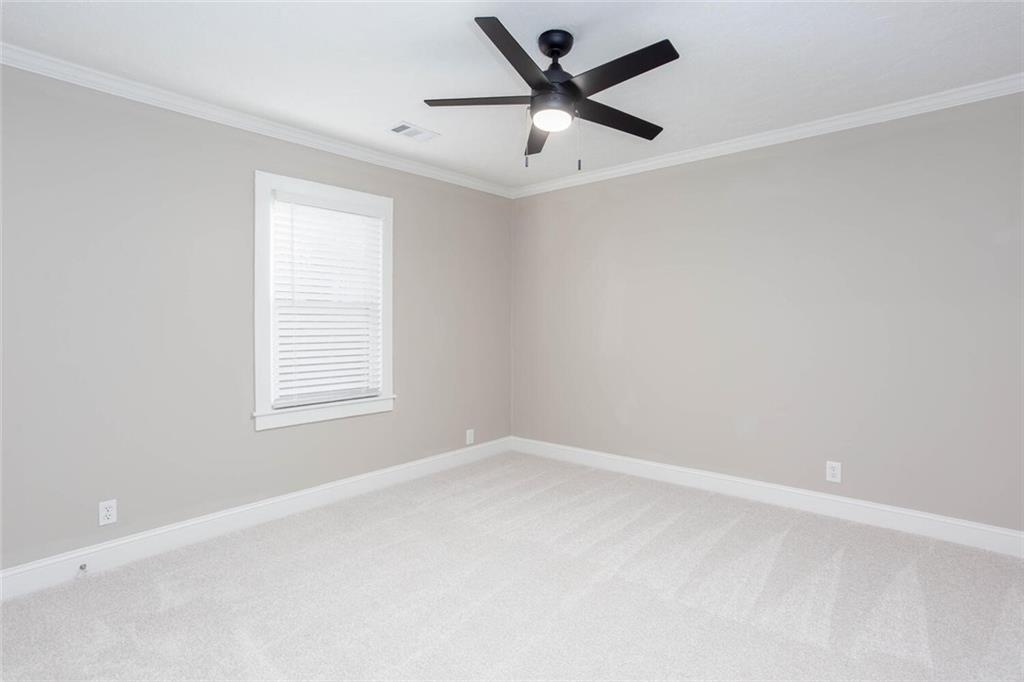 3831 Dillard Street Powder Springs, GA 30127 - Photo 16 of 30 an empty room with a window and a ceiling fan