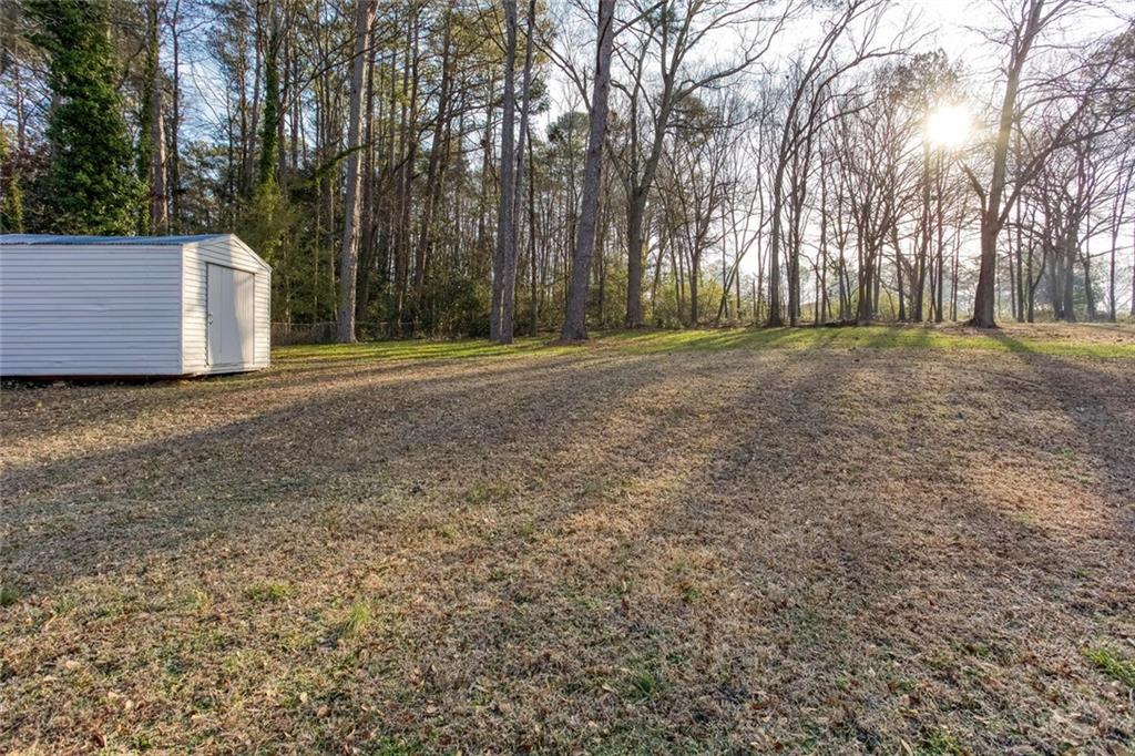 3831 Dillard Street Powder Springs, GA 30127 - Photo 23 of 30 a view of a house with large trees