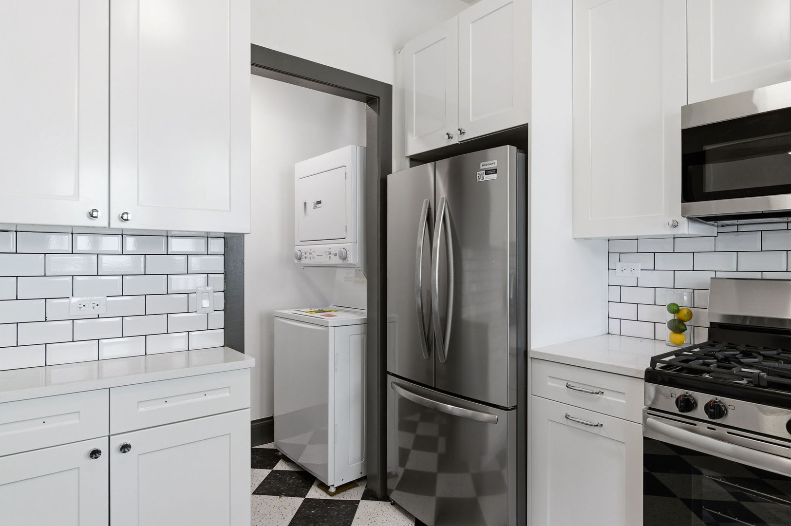 2920 West Altgeld Street, Unit 2 Chicago, IL 60647 - Photo 10 of 22 a kitchen with refrigerator a stove and a microwave